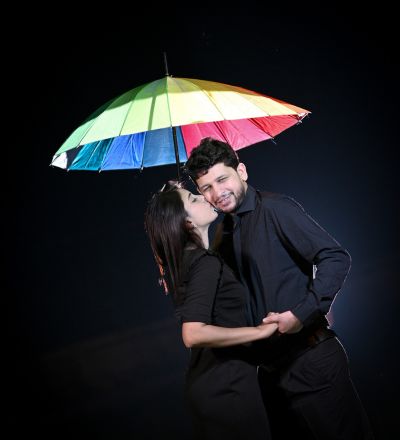 "Romantic pre-wedding night shoot with colorful umbrella, couple candid moment by SK Photographer Ranchi, creative pre-wedding photography in Jharkhand."
