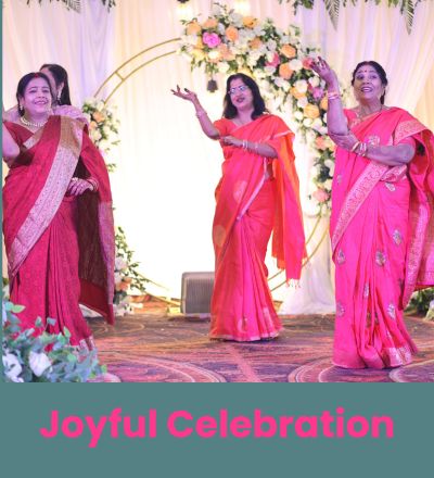 "Joyful ladies dancing at an Indian wedding event in traditional sarees, captured by SK Photographer Ranchi, candid celebration photography."