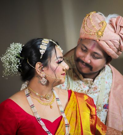 "Traditional Indian bride and groom candid moment, groom admiring bride in Maharashtrian-style wedding attire, captured by SK Photographer Ranchi."