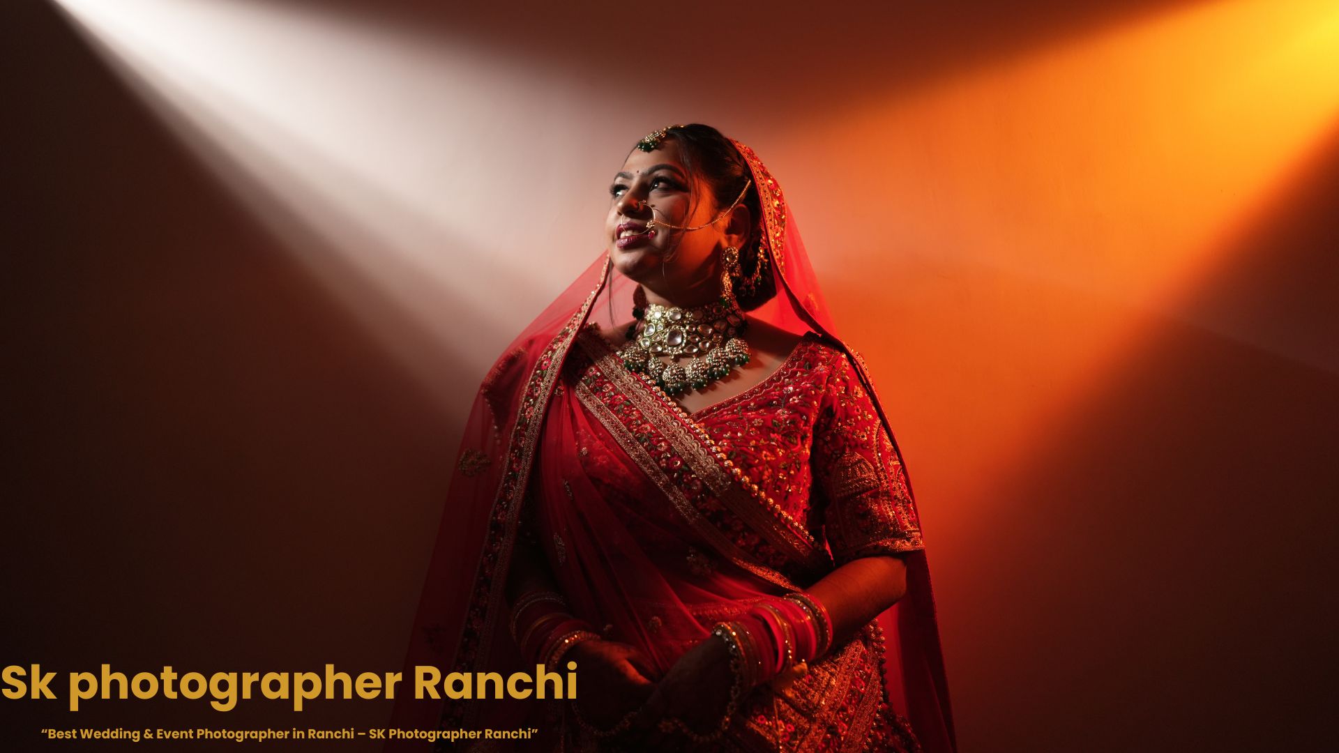 Indian bride in red bridal lehenga under cinematic spotlight lighting, captured by SK Photographer Ranchi wedding photography.