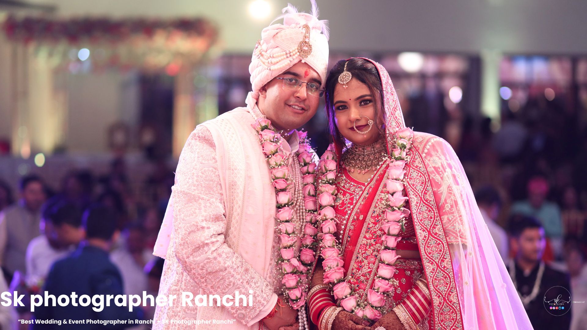 Newlywed Indian couple in traditional wedding attire smiling together with rose garlands, captured by a Wedding Photographer in Ranchi. sk photographer Ranchi